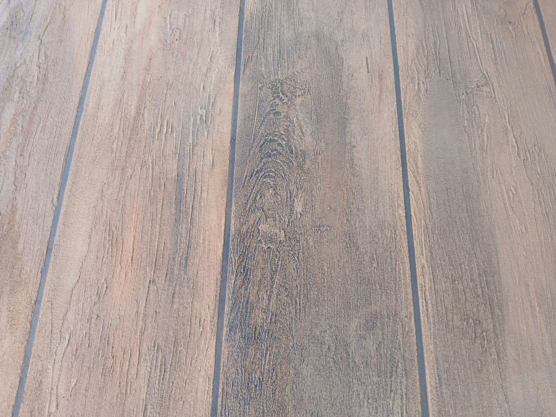 light brown wood plant finish concrete— Troys Concrete Overlays in Hillcrest, QLD