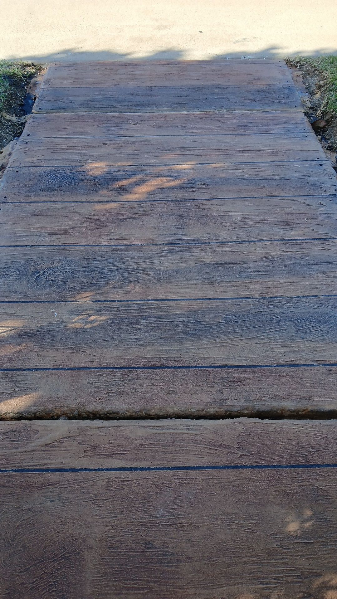 Dark brown wood plank finish concrete— Troys Concrete Overlays in Hillcrest, QLD