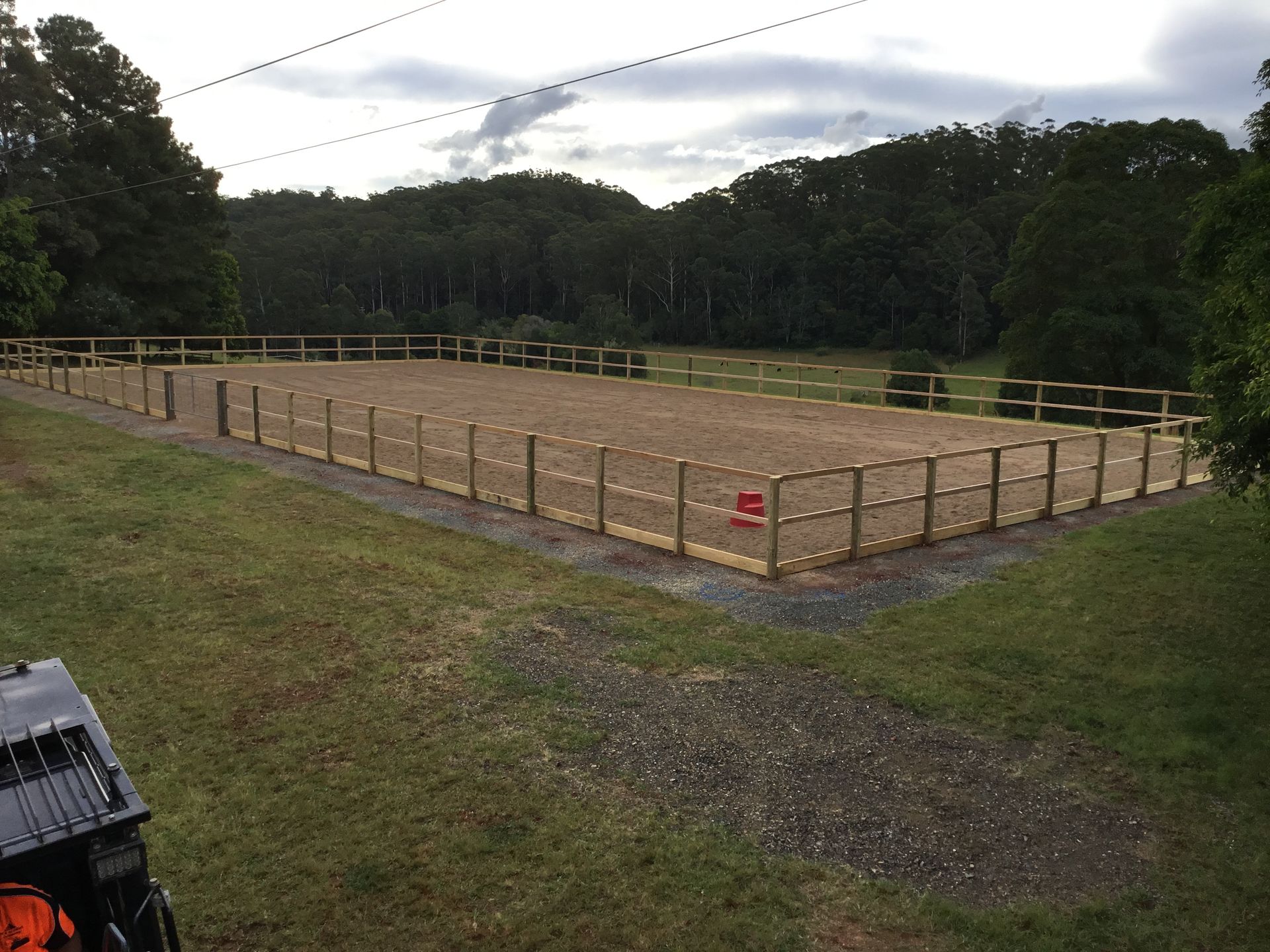 A Fenced Equestrian Arena With Tan Footing Surrounded by a Gravel Pathway — S M & A J Gilbert Earthmoving in Mitchells Island, NSW