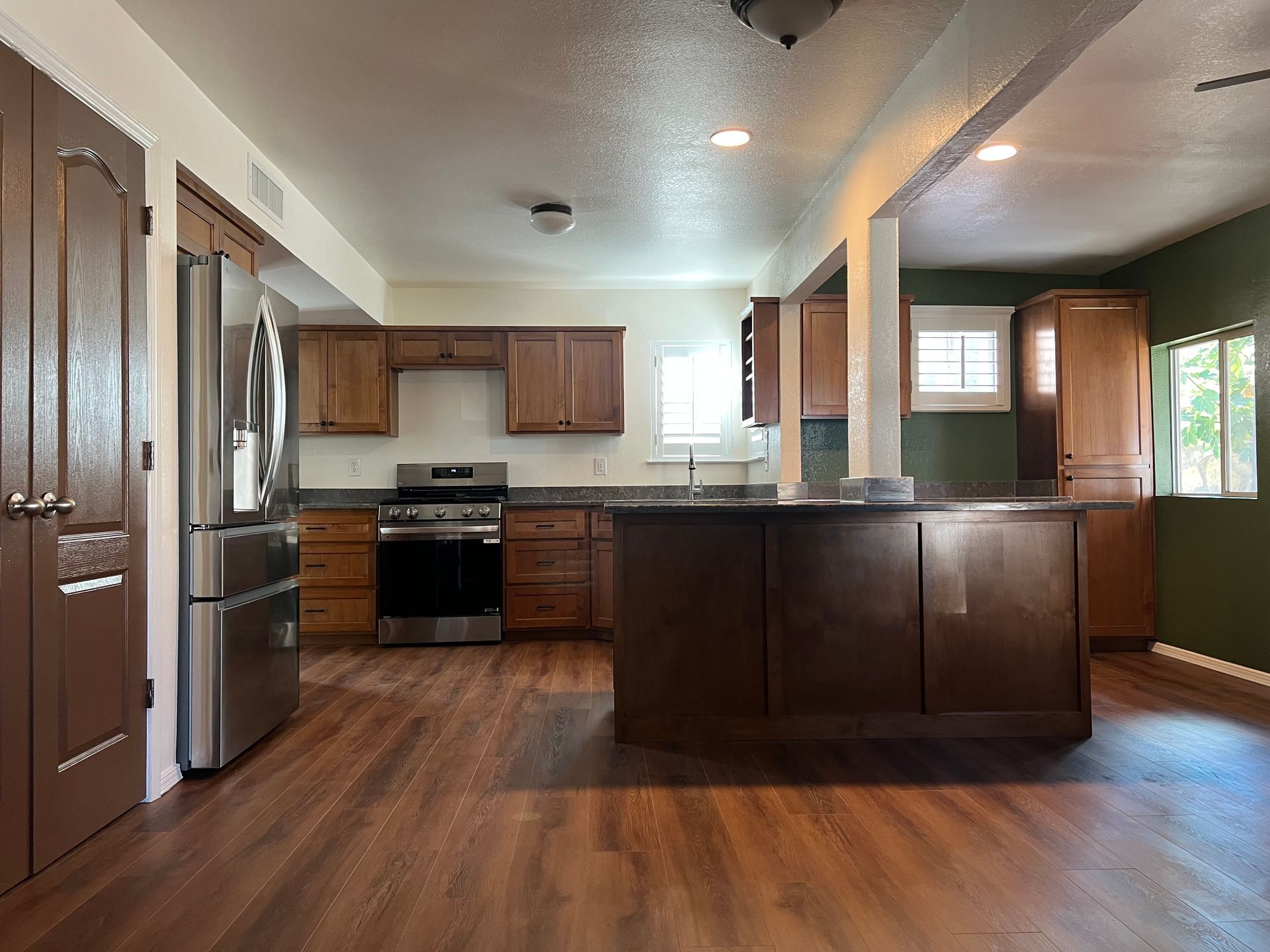 Kitchen with wood cabinets, stainless steel appliances, and dark countertops.