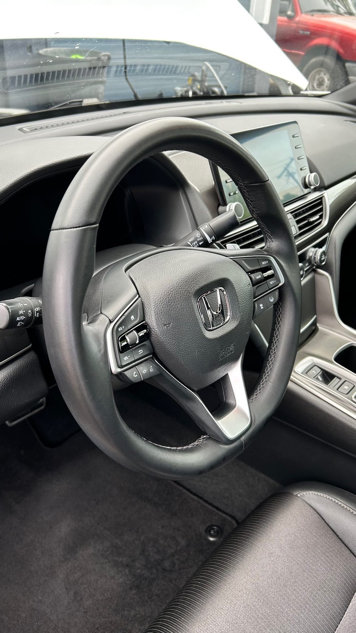 A close up of a steering wheel in a car.