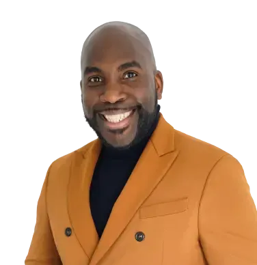Smiling person wearing an orange blazer and black turtleneck.