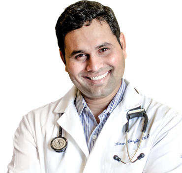 Doctor smiling, wearing white coat and stethoscope.