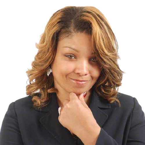 Woman in a dark suit, touching chin, looking thoughtfully to the side. Blonde and brown wavy hair.