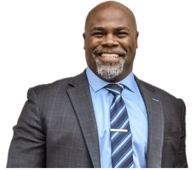 Man in a gray suit smiles, light blue shirt, blue striped tie, and a silver beard.