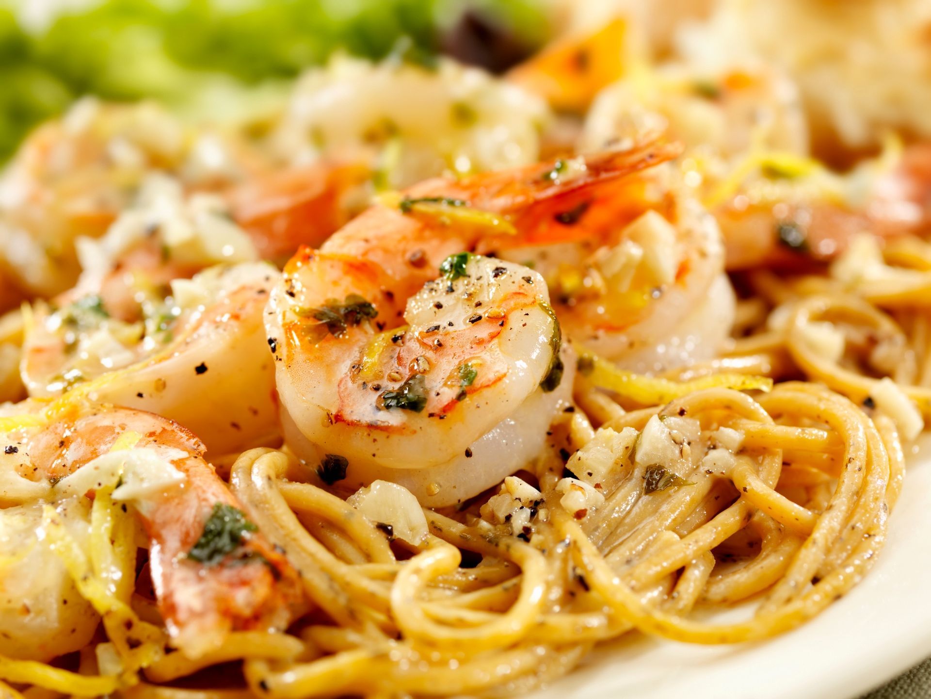 Shrimp pasta with creamy sauce and herbs, served in a close-up view