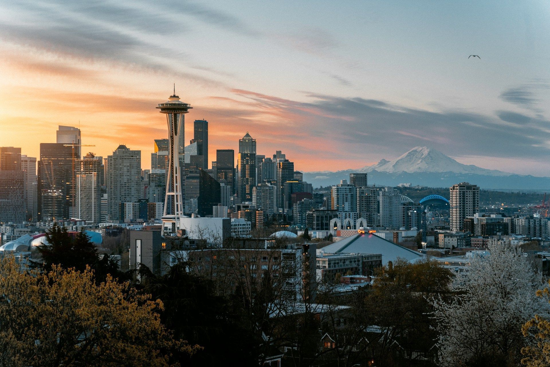 Seattle skyline at sunset with the Space Needle and Mount Rainier in the distance