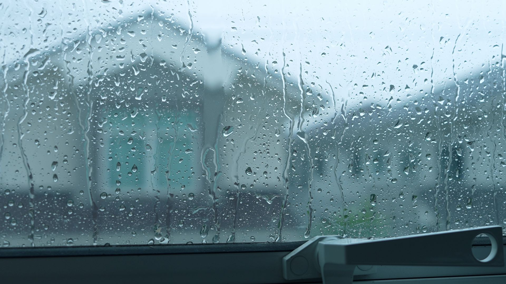 Raindrops on glass showing window waterproofing keeping a storm outside