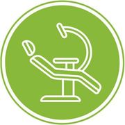 An icon of a dental chair with a microscope in a green circle.