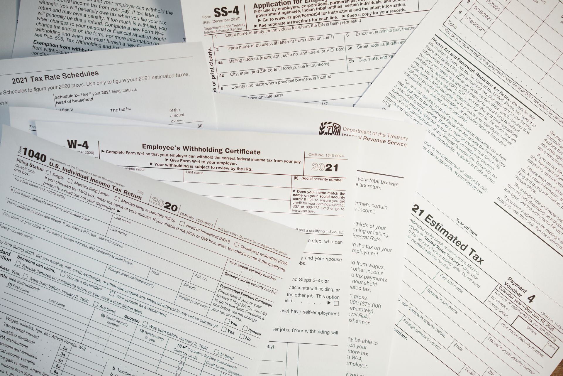Scattered black-and-white typed pages and forms spread across a white surface