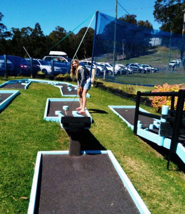 Girl Playing Mini Golf In The Big Buzz Fun Park in Rainbow Flat, NSW