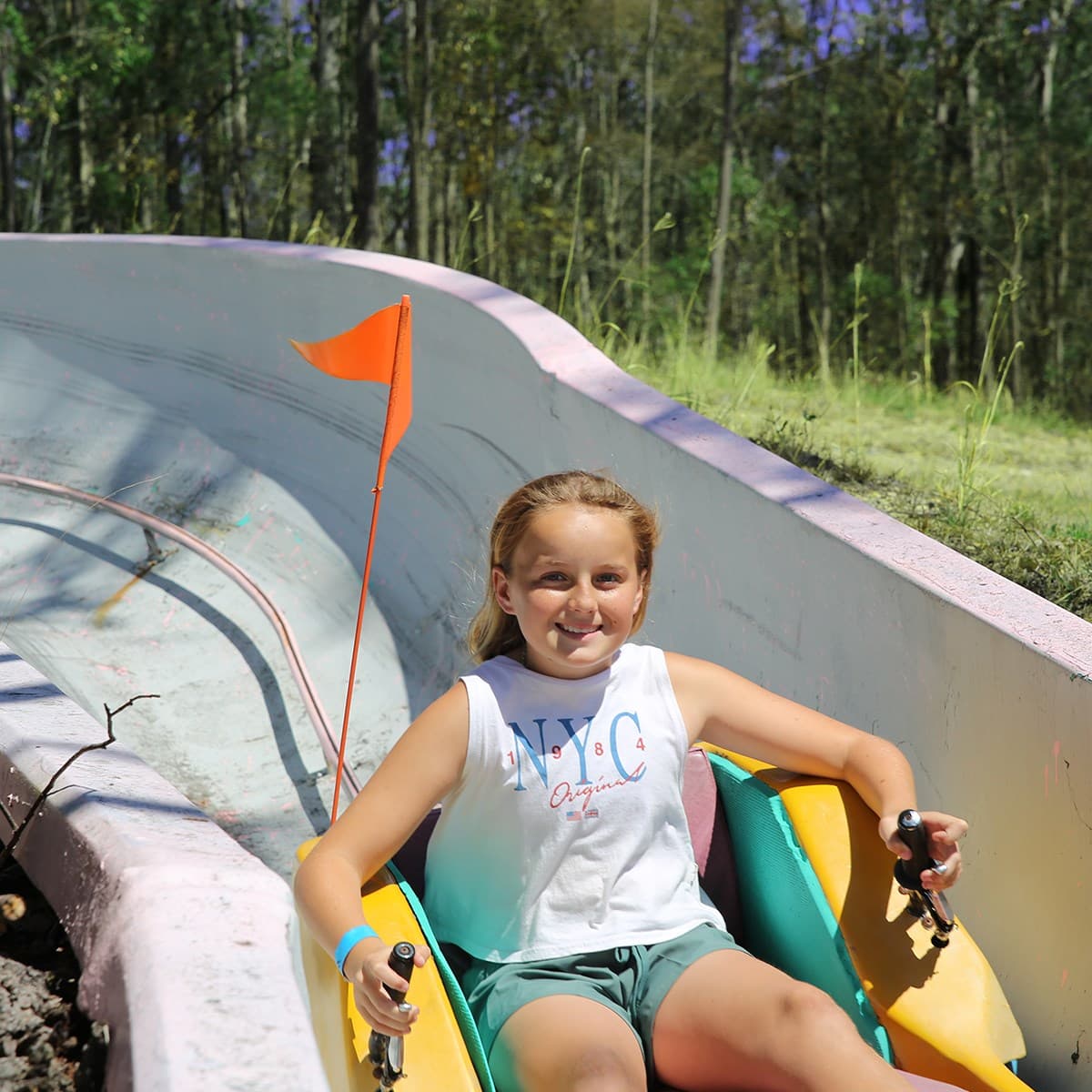 Girl Enjoying the Toboggan Ride In The Big Buzz Fun Park