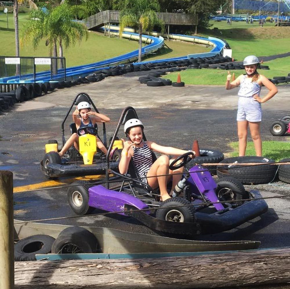 Children Enjoying Amusement Park Go-karts
