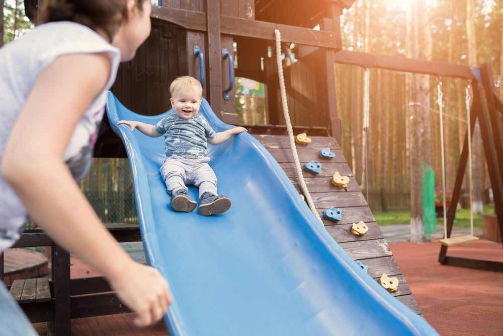 Mother And Her Baby Boy Playing In The Park
