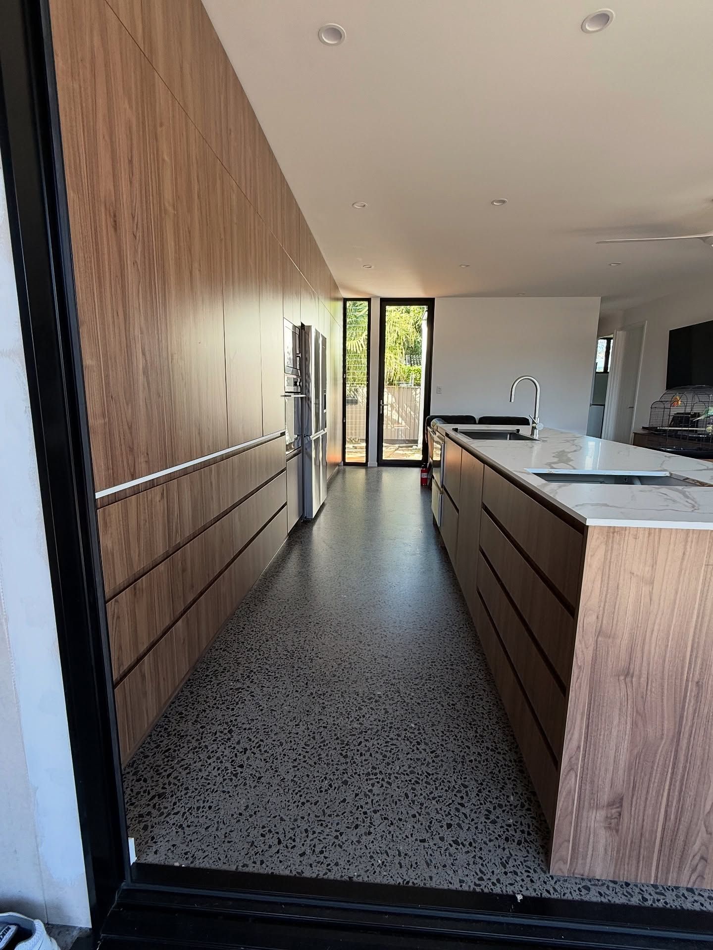 Modern Kitchen With Wood-paneled Island, Stainless Refrigerator — Sunny State Carpentry and Joinery In Hope Island, QLD