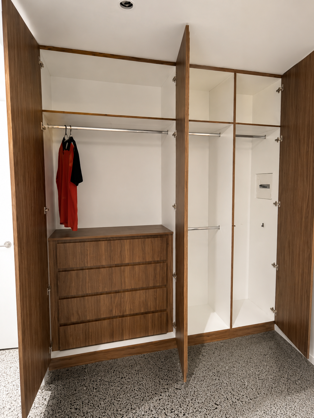 Empty Walk-in Closet With White Shelving and Wood-look Floor — Sunny State Carpentry and Joinery In Hope Island, QLD