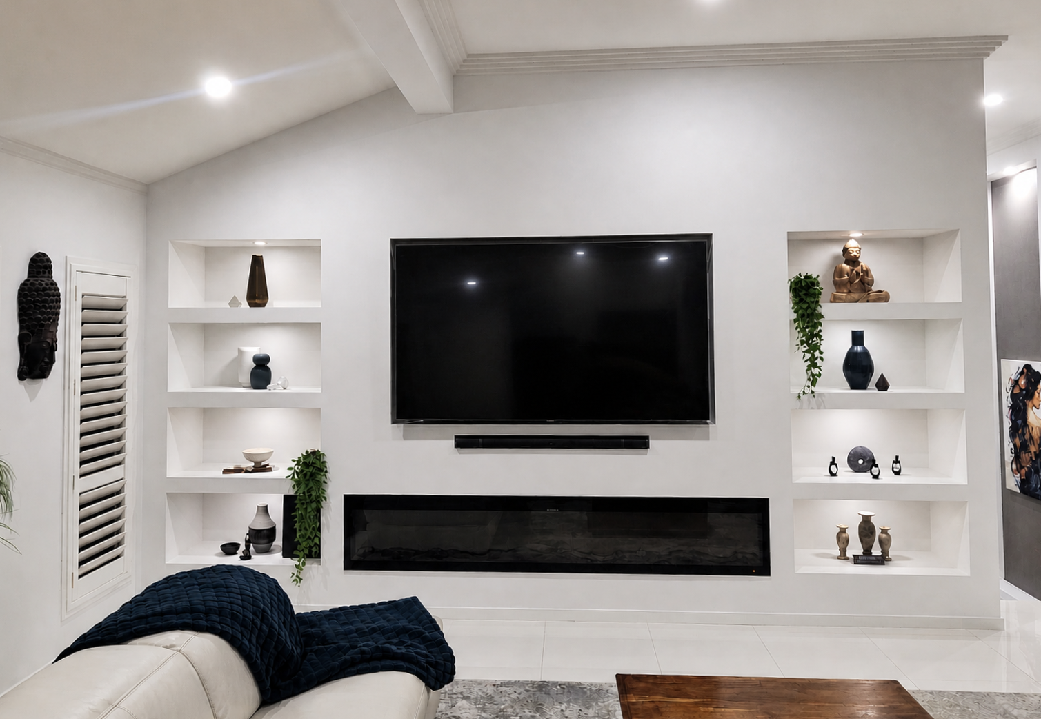 Modern living room with wall-mounted TV, built-in shelves, fireplace, and white walls