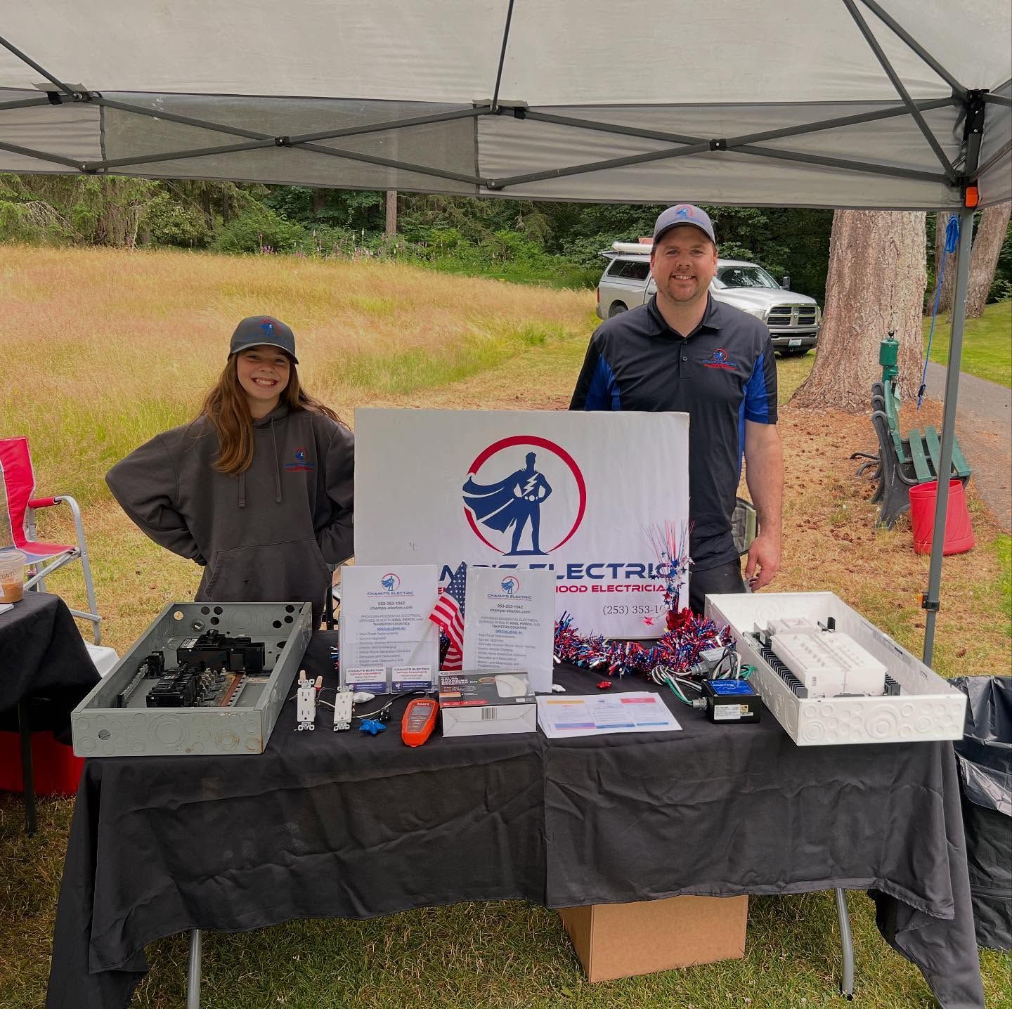 Two people at an outdoor booth for 