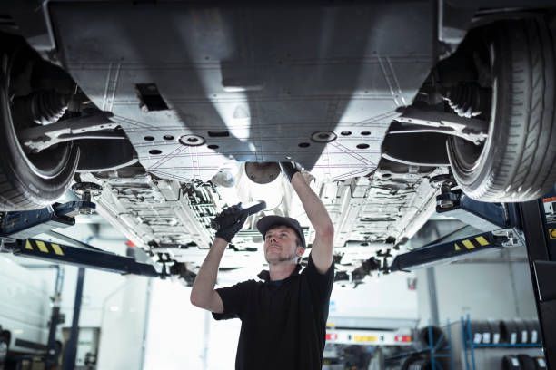 A Man Is Working Under a Car in A Garage | El Paso, TX | Jerry’s Auto Repair & Tire