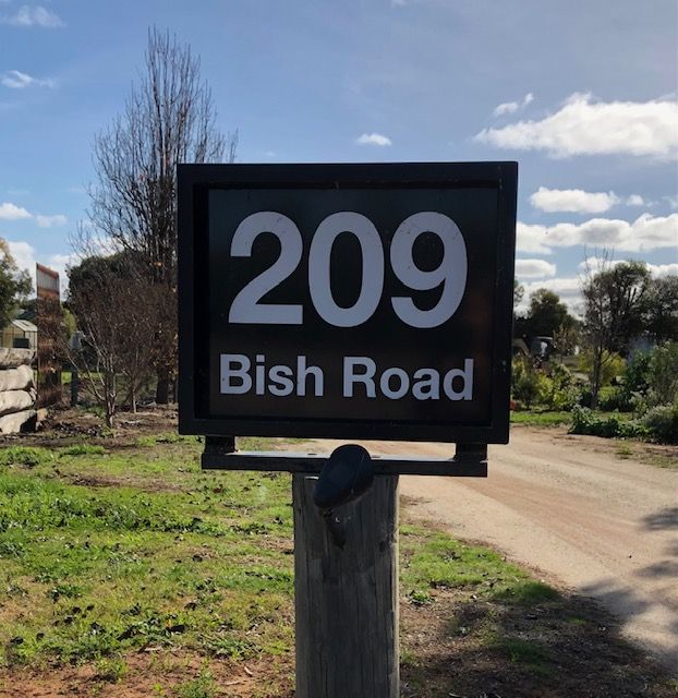 A sign that says 209 bish road on it