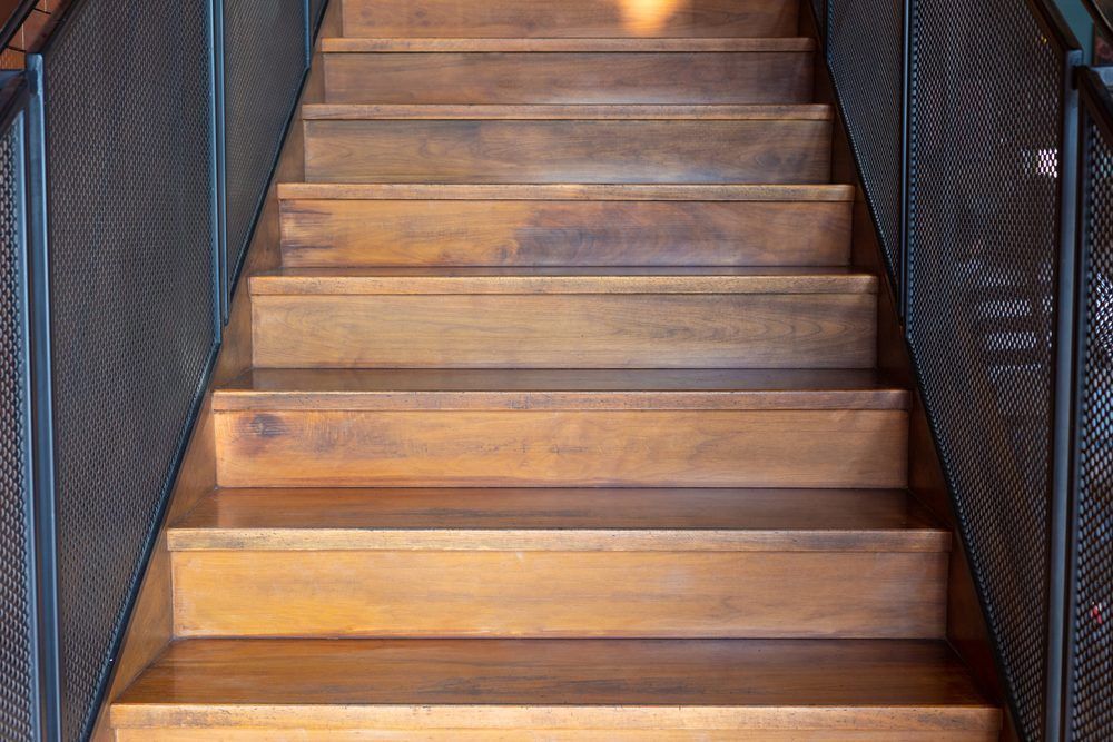 Wooden staircase with metal railings on both sides