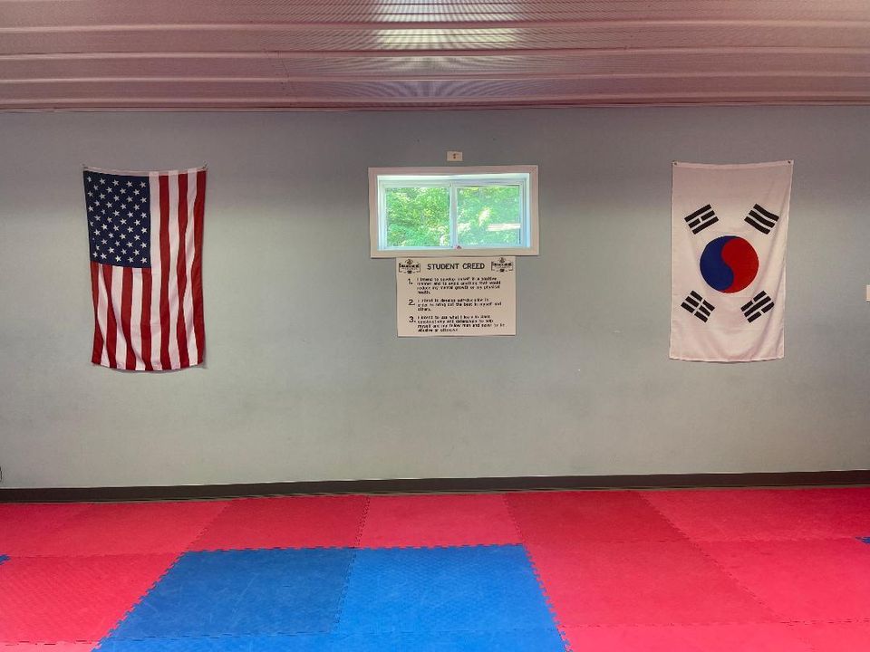 An american flag and a korean flag are hanging on a wall