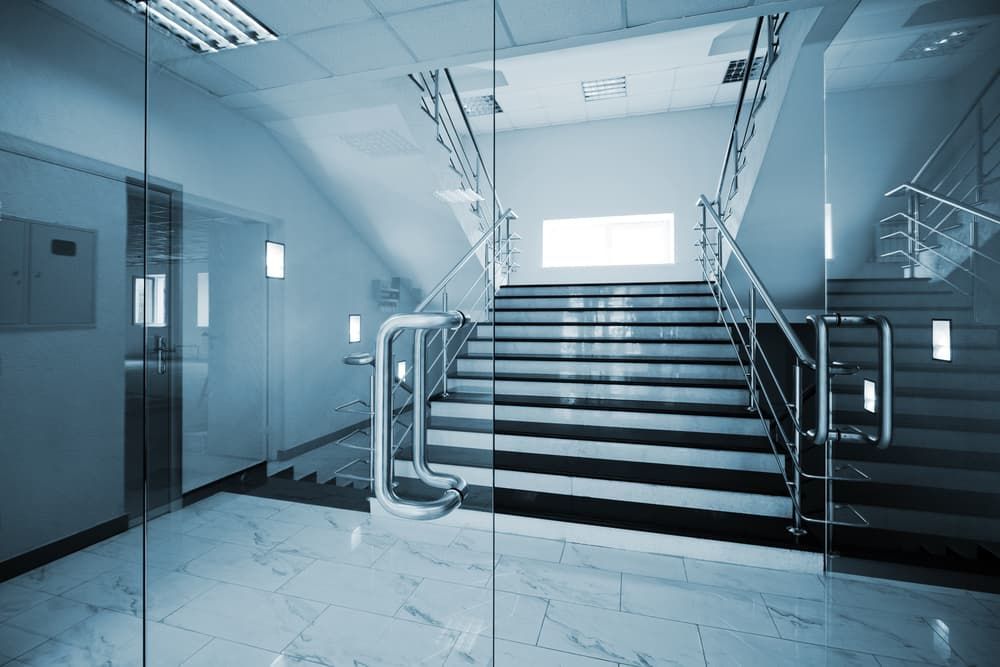 An Elegant Marble Staircase With Glass Doors - Glass Repair in Gold Coast, QLD