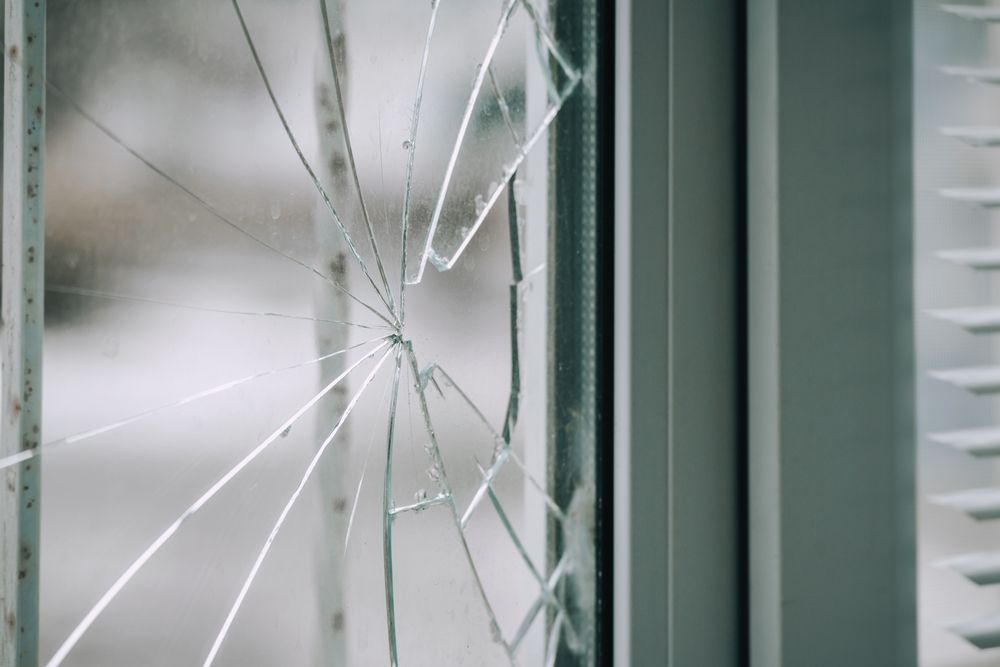 Cracked Glass Window With a Spiderweb Pattern