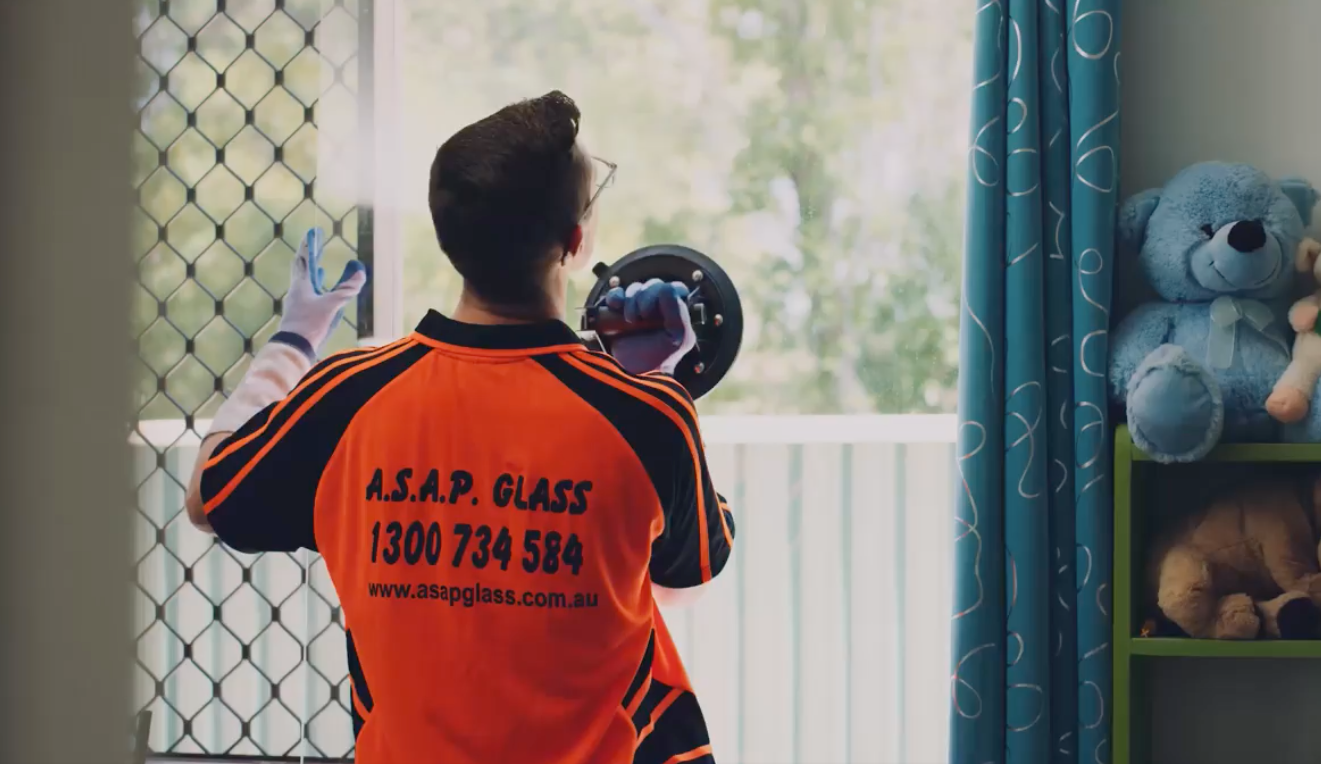 Tradesman Uses a Suction Lifter on the Window - Glass Repair in Gold Coast, QLD