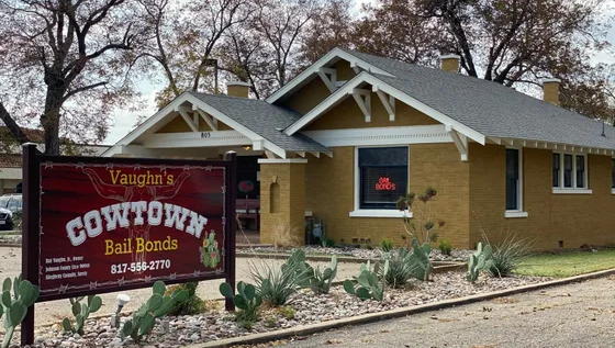 A brown house with a sign in front of it that says cowtown