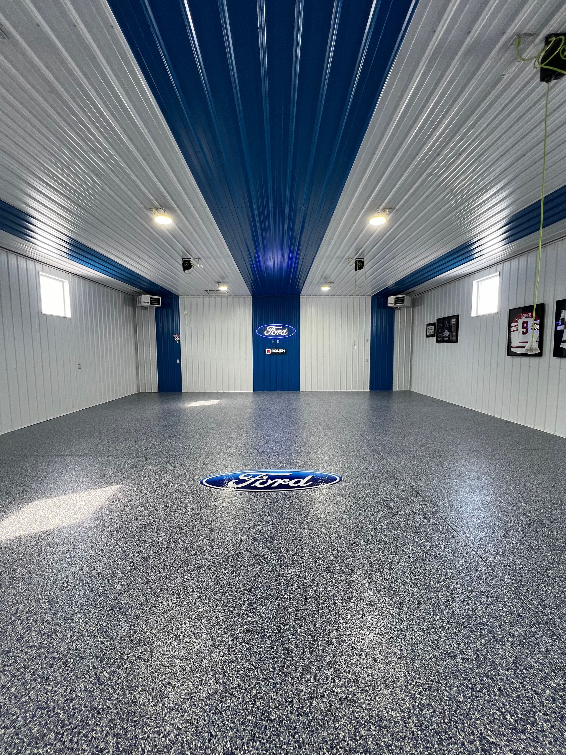 A large empty garage with a blue and white ceiling.