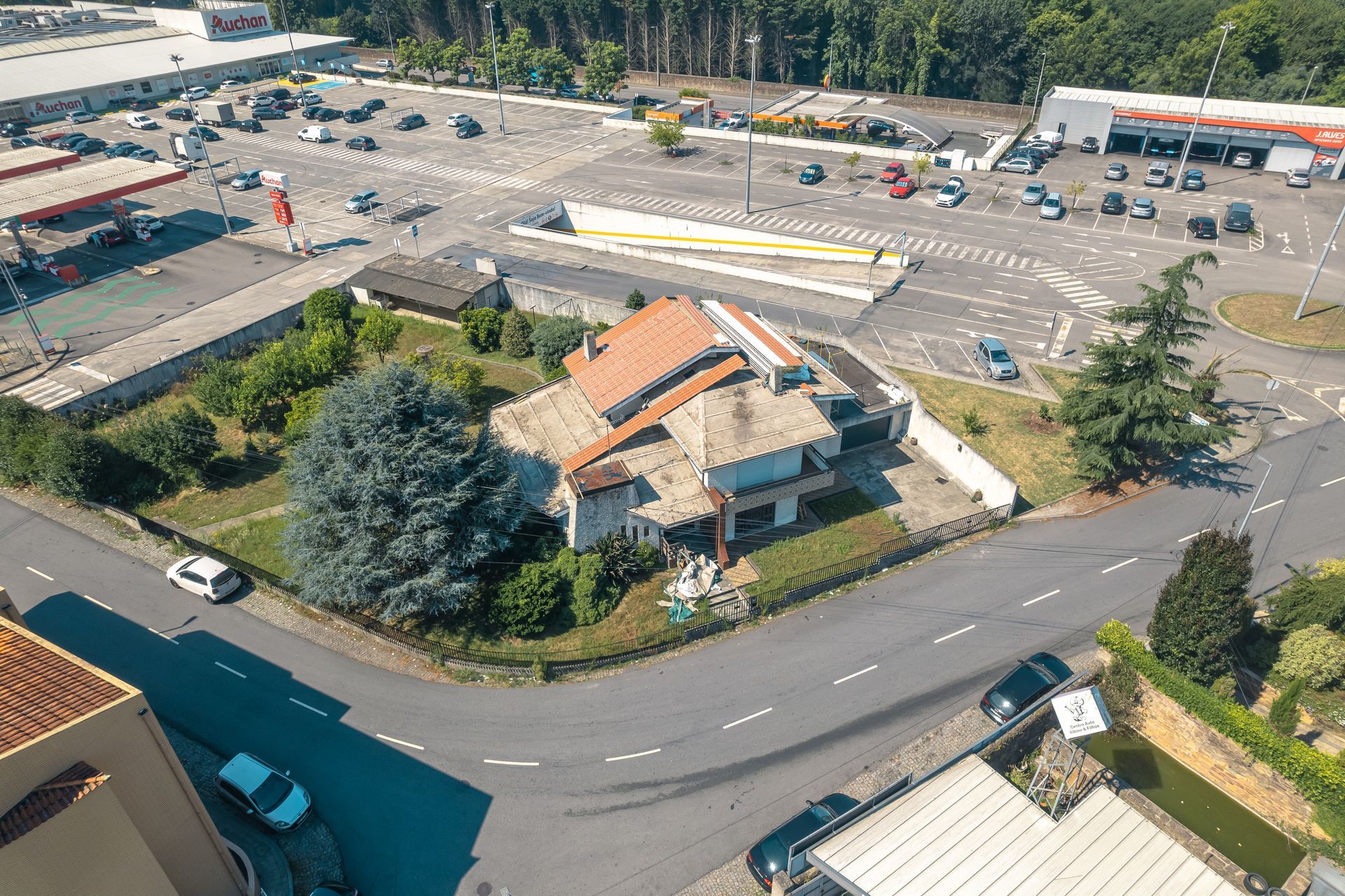 Uma vista aérea de uma casa com telhado painel sandwich imitação de telha lusa 45mm laranja RAL8004