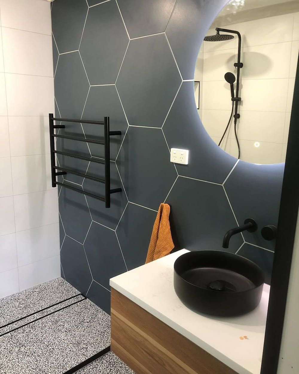 A Kitchen With Black and White Cabinets and a Clock on the Wall — Canberra Bathroom Solutions in Belconnen, ACT