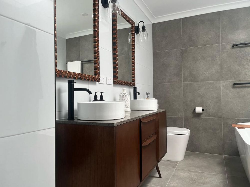 A Bathroom With Two Sinks a Toilet  and a Mirror — Canberra Bathroom Solutions in Ngunnawal, ACT