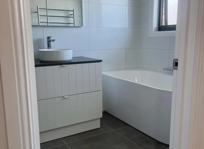 A Bathroom With White Vanity An Large Wall Tiles — Canberra Bathroom Solutions in Ngunnawal, ACT