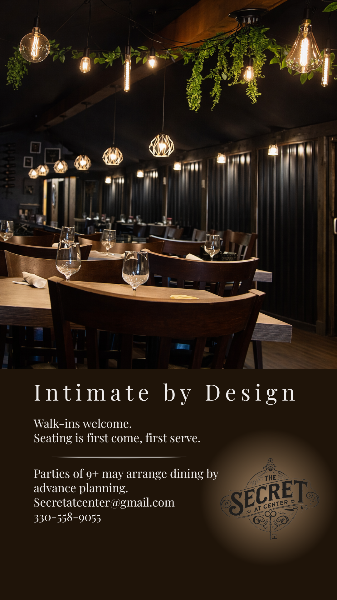 Dimly lit elegant restaurant interior with hanging plants, warm pendant lights, and set dining tables.