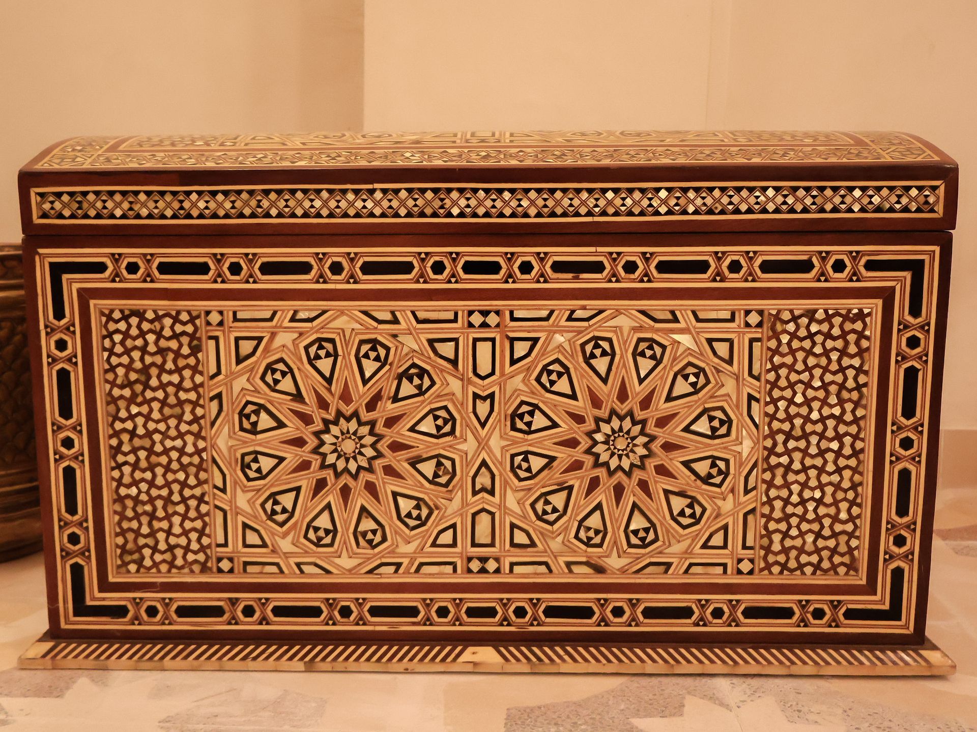 Ornate wooden chest with intricate geometric inlay designs.