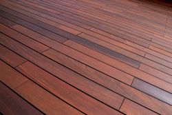 Close-up of reddish-brown wooden deck boards with a few gray planks