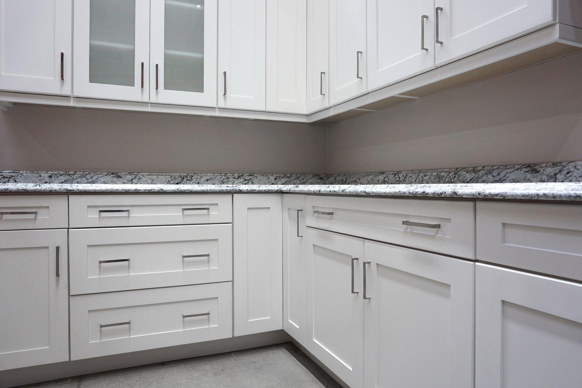 A close-up on a white cabinet in a modern kitchen. A close-up on a white cabinet in a modern kitchen.