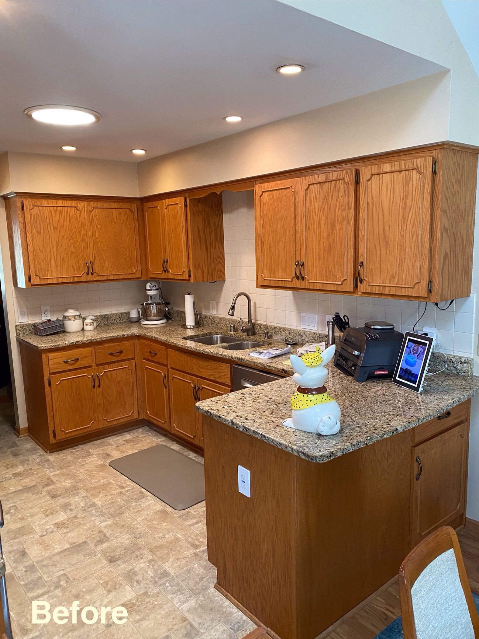 Compact kitchen with wood cabinets, granite countertops, stainless sink, and a small island; marked “Before.”