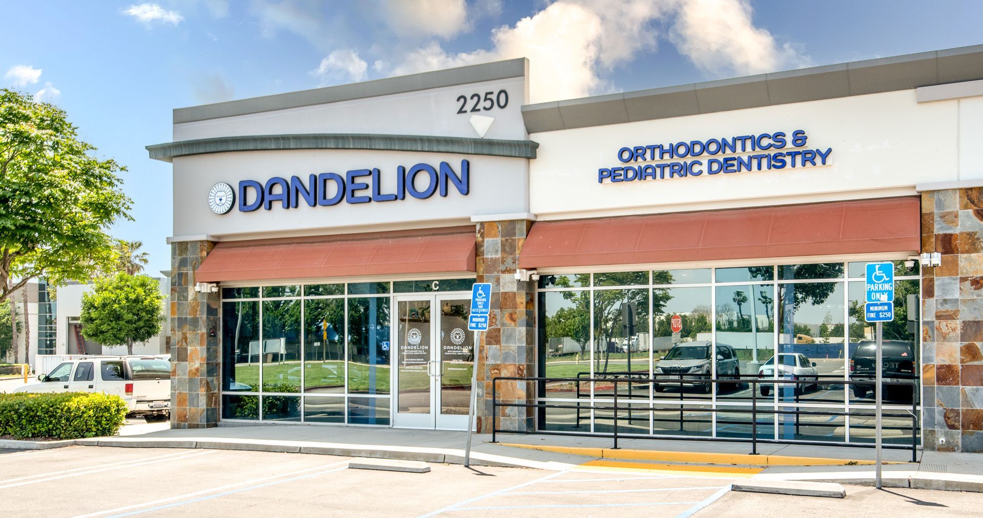 Dandelion Orthodontics & Pediatric Dentistry office exterior with awning, blue and tan facade, and accessible parking.
