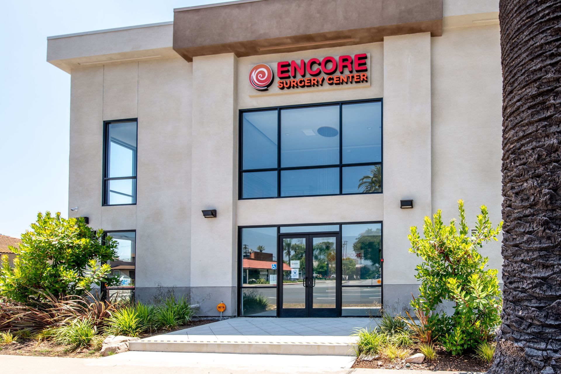 Encore Vein Center building exterior with glass doors and windows; red logo above the entrance.