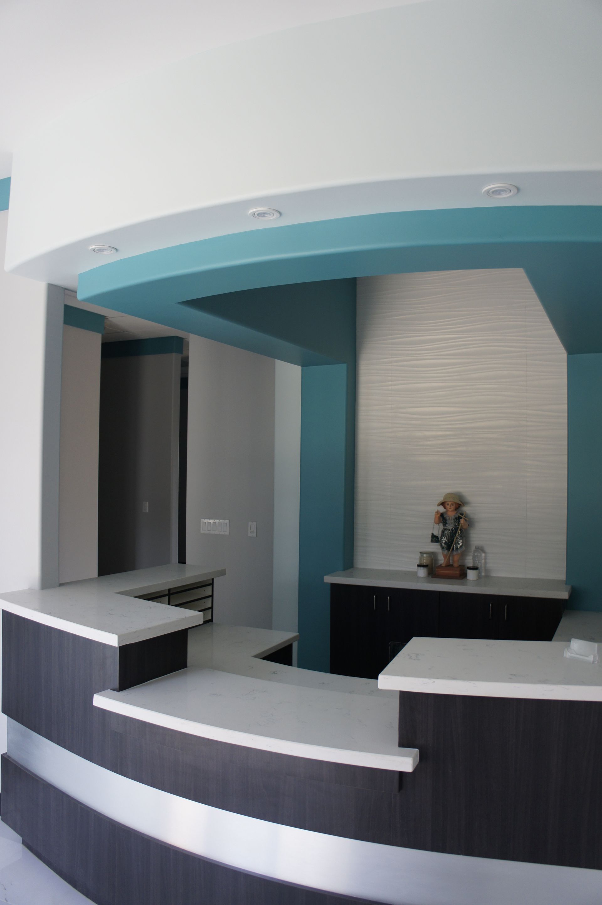Reception desk in a modern office setting with a blue and white design.