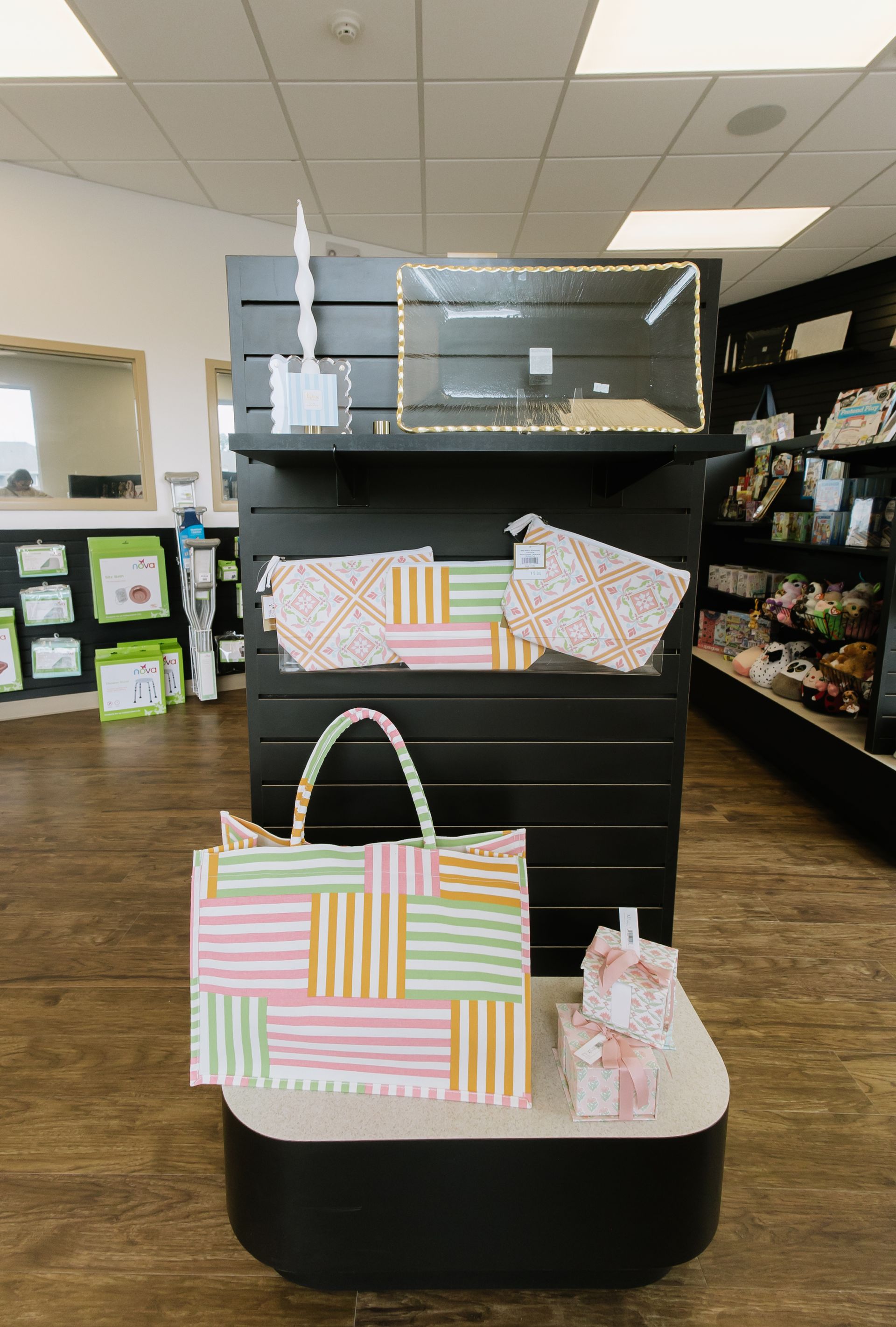 Pastel striped bags displayed on a store shelf in a retail shop