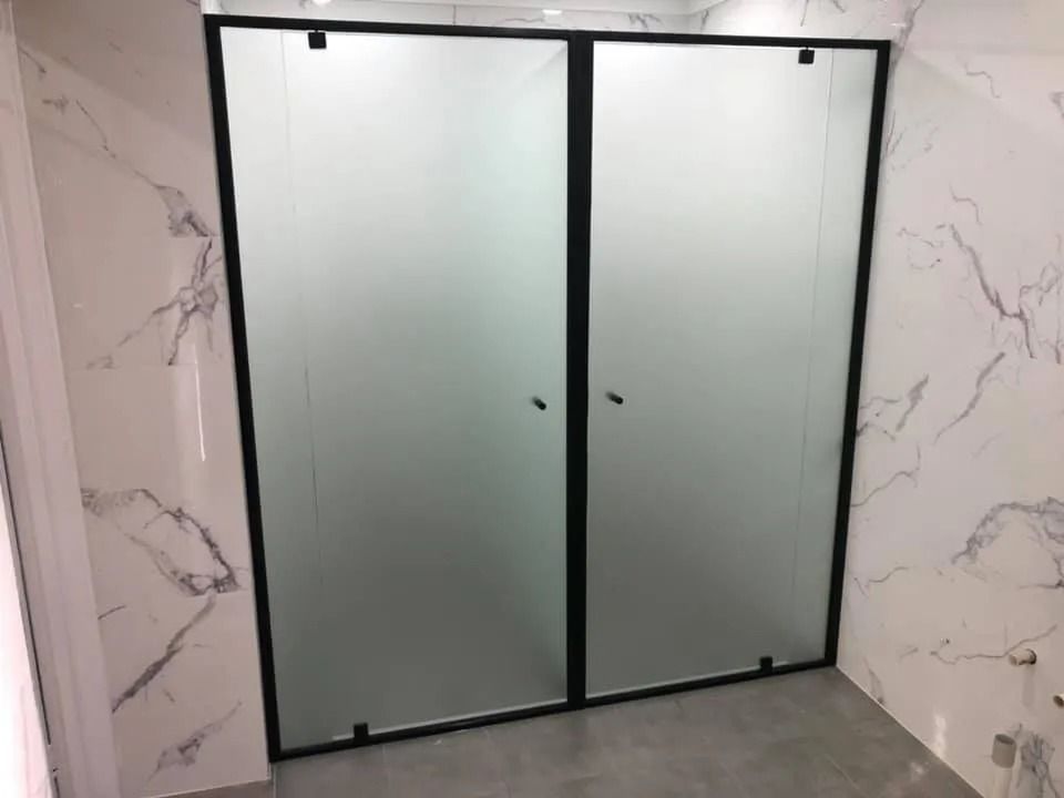 A double door glass shower screen with black frames — Gads Glass & Shower Screens in Kiama, NSW