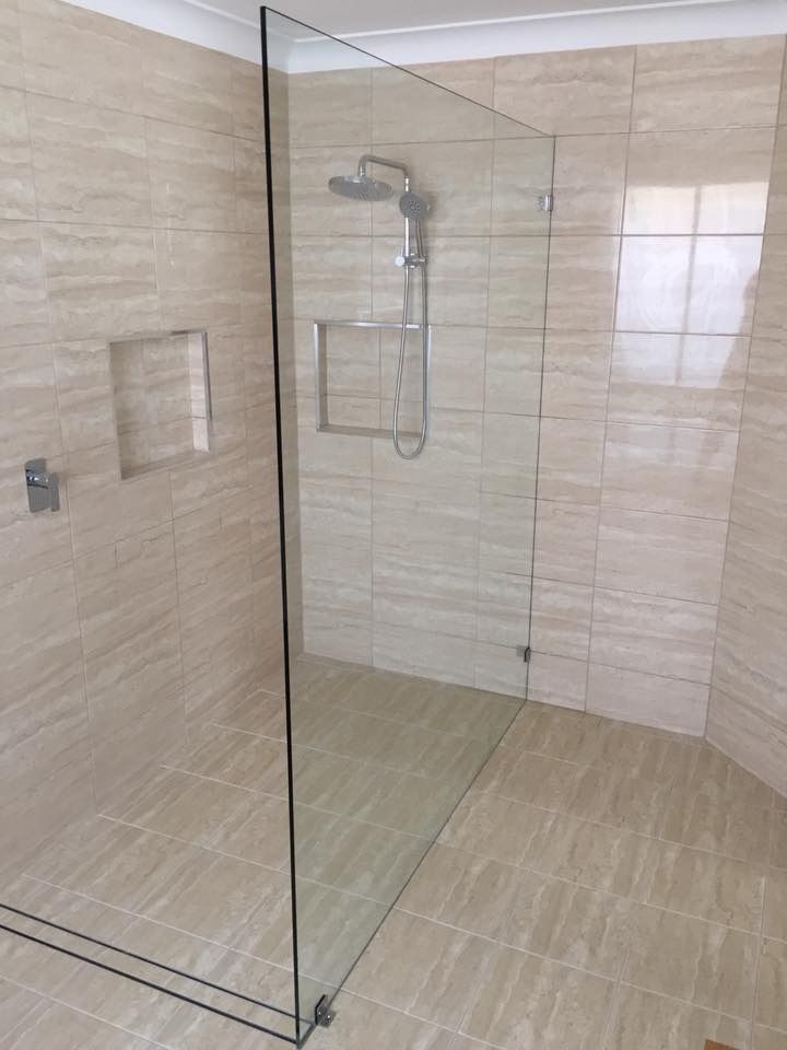 A Bathroom with A Walk in Shower and A Shower Head — Gads Glass & Shower Screens in Albion Park, NSW