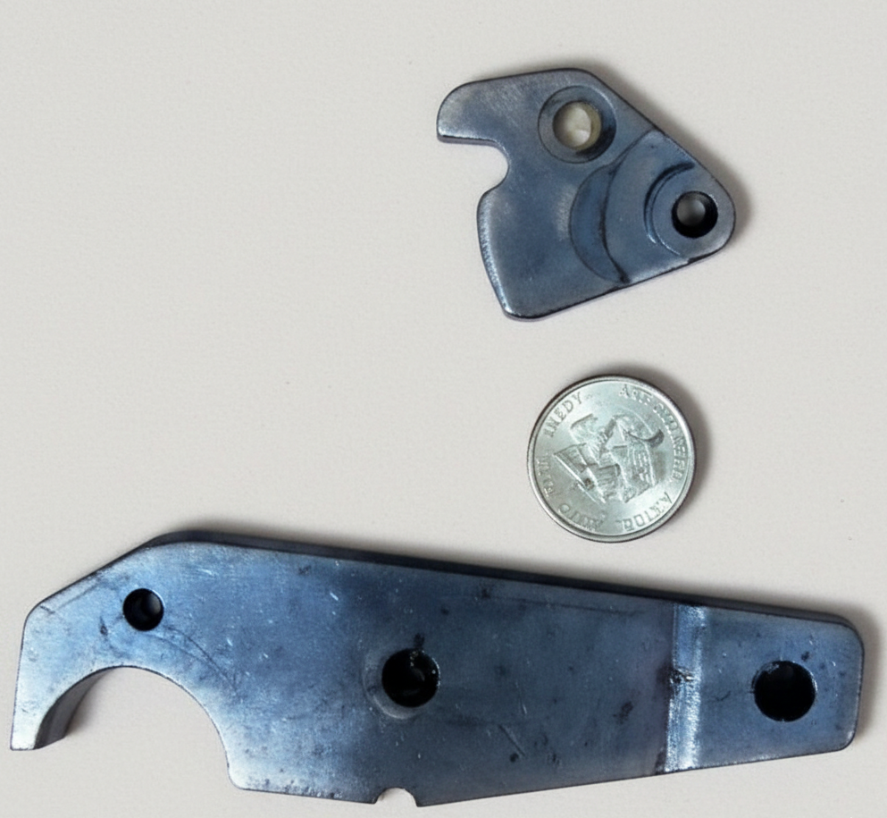 Curved conveyor belt with parallel metal rollers; blue motor on the left.