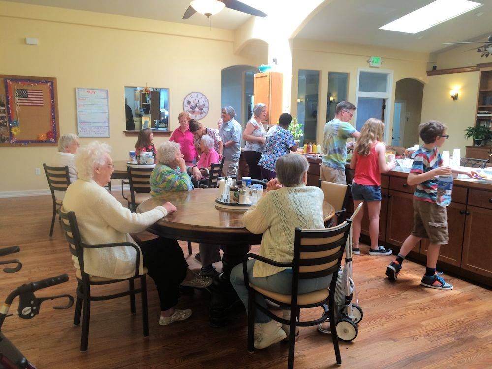A group of people are sitting at tables in a room.