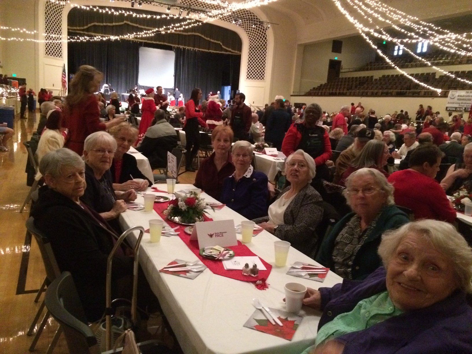 A group of people are sitting at tables in a large room