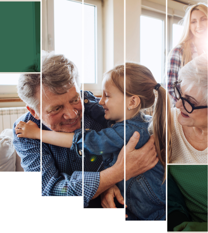 Three generations embrace in a bright home, smiling and holding each other close.